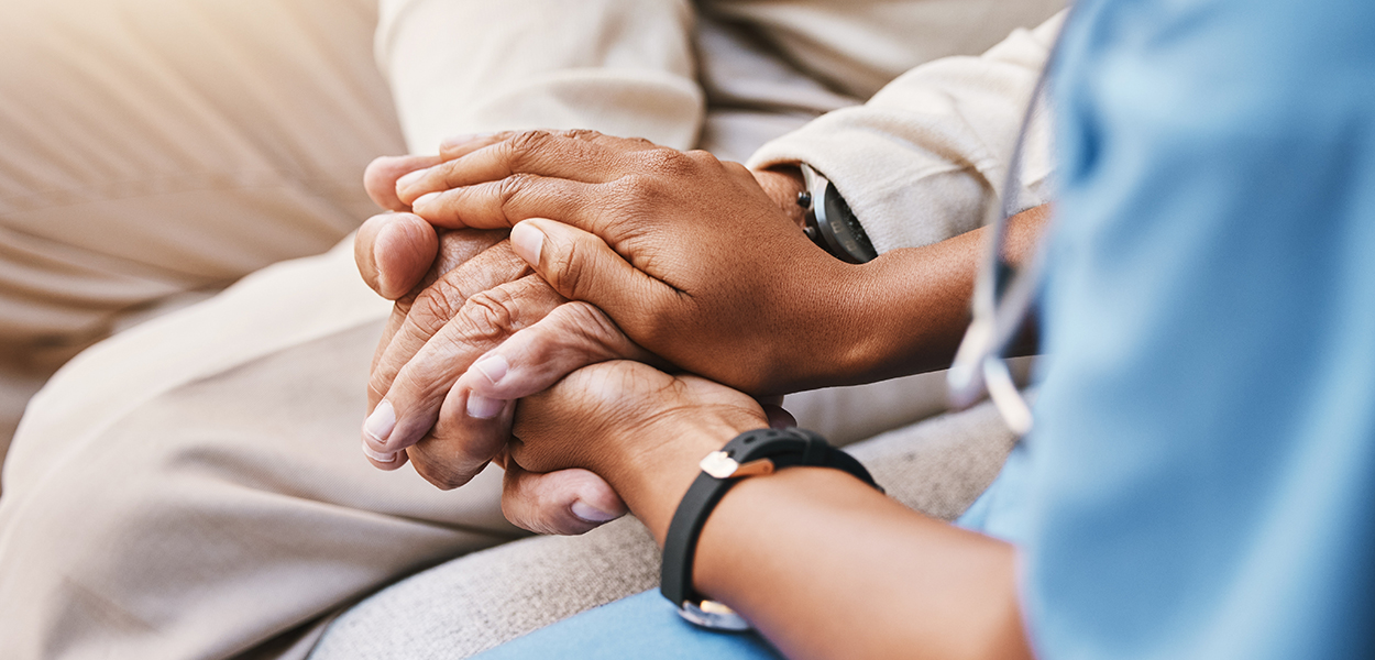 Image of nurse comforting an elderly person.