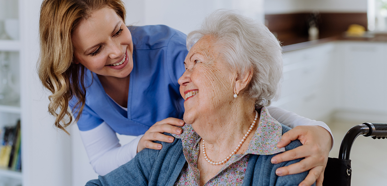 Image of nurse caring for elderly person in a wheelchair.